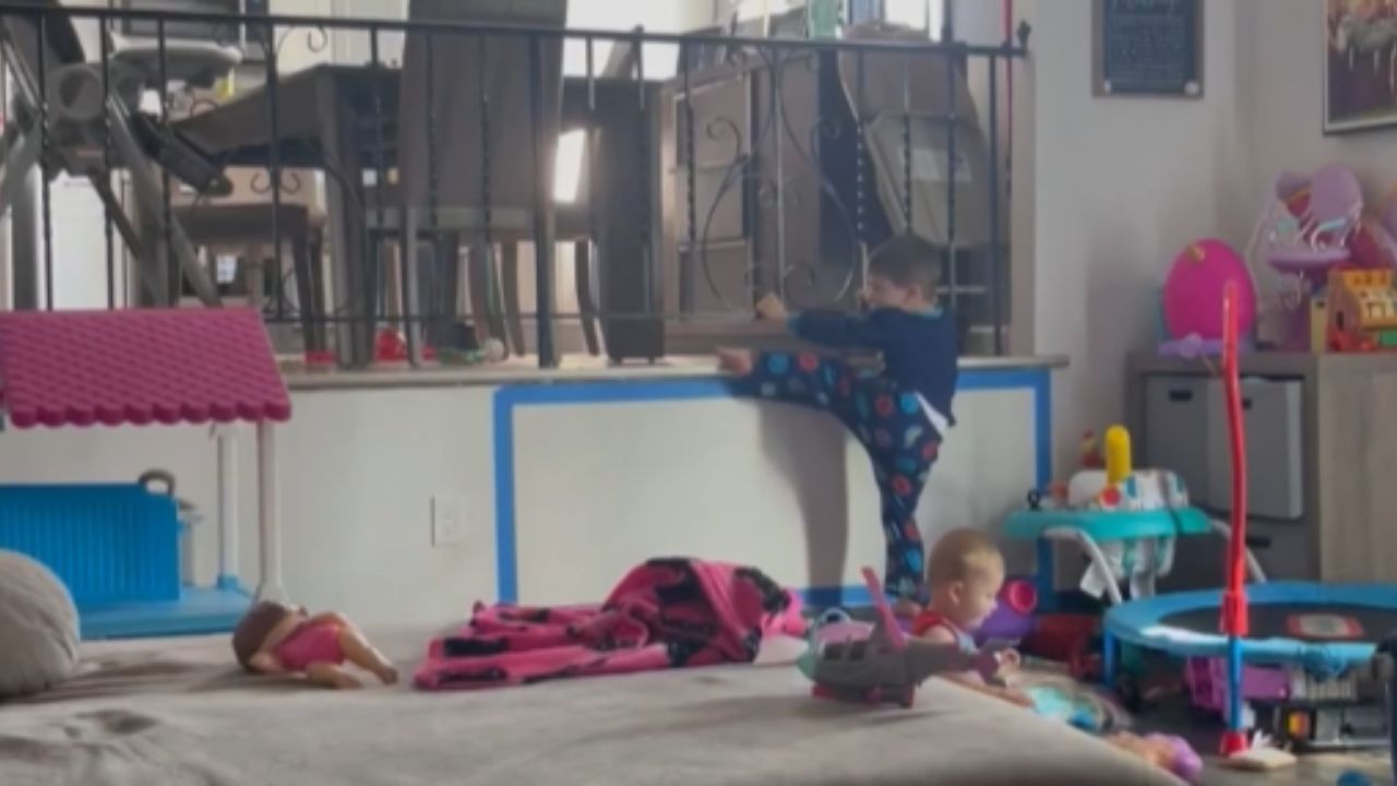 Toddler climbs through banister spindles to reach top floor